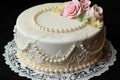 artfully decorated ring cake with lace and pearl accents