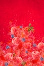 Artfully and lovingly designed photomontage with raspberries, blackberries, strawberries and water splashes in the