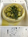 Artichoke cooked with peas and olive oil on table