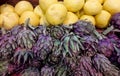 Artichokes and Pamelo fruits for sale on farming market.