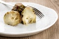 Artichokes in plates or bowl with fork Royalty Free Stock Photo