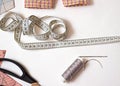 Articles for cutting and sewing. Measuring tape and threads . Royalty Free Stock Photo