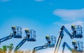 Articulated boom lift. Aerial platform lift. Telescopic boom lift against blue sky. Mobile construction crane for rent and sale. Royalty Free Stock Photo