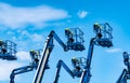 Articulated boom lift. Aerial platform lift. Telescopic boom lift against blue sky. Mobile construction crane for rent and sale. Royalty Free Stock Photo