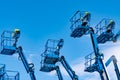 Articulated boom lift. Aerial platform lift. Telescopic boom lift against blue sky. Mobile construction crane for rent and sale. Royalty Free Stock Photo