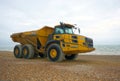 Articulated dump truck. The Bell B40D on pebbled beach.