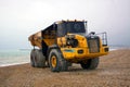 Articulated dump truck. The 29 ton Bell B40D on pebbled beach.