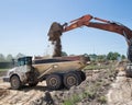 Articulated dumper at a construction site during loading and transporting soil