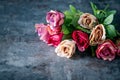 Artificial antique roses on stony background. Royalty Free Stock Photo