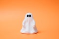 Artificial beautiful ghost on an orange background. Copy space for text. Festive concept