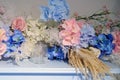 Artificial blue and red flowers, plants and an empty glass on the piano lid, close-up Royalty Free Stock Photo