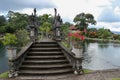 An artificial bridge with four statues of dragons with twisted tails, Tirta Gangga park, Karangasem region of Bali Royalty Free Stock Photo