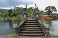 An artificial bridge with four statues of dragons with twisted tails, Tirta Gangga park, Karangasem region of Bali Royalty Free Stock Photo