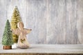 Artificial Christmas tree on a wooden background.