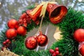 Artificial Christmas Wreath with Red Ornaments, Red Jingle Bells and Golden Ribbon on an Entrance Door of a Restaurant Royalty Free Stock Photo