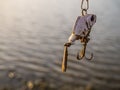 Artificial dam lake and artifisial fish with hook for fishing the shore bank.