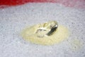 Artificial diamonds lying in the sand photographed in the studio with flash light Royalty Free Stock Photo