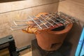 Artificial dried grill and crushed squid in Thai style on vintage clay stove