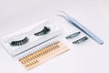 Artificial false fluffy eyelashes with tweezers. Royalty Free Stock Photo