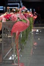 Artificial flamingo bird decoration in a shopping mall. Romantic cafe interior with flowers Royalty Free Stock Photo