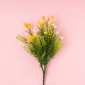 Artificial flower on light pink background