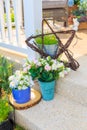 An artificial flowers in blue pot on floor in a porch. Royalty Free Stock Photo