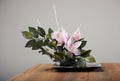 Artificial flowers bouquet in vase on the table