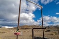 Artificial flowers hang next to the rusty turnstile of a desert cemetery in western Nevada, USA