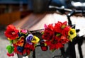 Artificial flowers on a metal bike basket