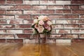 Artificial flowers put on terrace wood with brick wall in vintage style