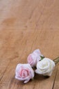 Artificial flowers on wooden board Royalty Free Stock Photo