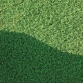 Artificial grass fake turf synthetic lawn field macro closeup, gentle shaded shadow area, green sports astroturf texture