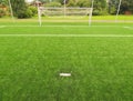 Artificial grass field on football playground. Detail of a cross of lines in a soccer field. Plastic grass and ground rubber Royalty Free Stock Photo