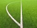 Artificial grass field on football playground. Detail of a cross of lines in a soccer field. Plastic grass and ground rubber Royalty Free Stock Photo