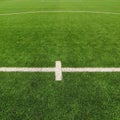 Artificial grass field on football playground. Detail of a cross of painted white lines in a soccer field. Plastic grass Royalty Free Stock Photo