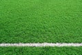 Artificial grass of football field with white stripe, Soccer corner line detail, Green astro turf for texture background Royalty Free Stock Photo