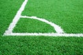 Artificial grass of football field with white stripe, Soccer corner line detail, Green astro turf for texture background Royalty Free Stock Photo