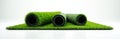Artificial grass rolls displayed on white background. Synthetic turf samples for sport fields, playgrounds, or landscaping. Easy Royalty Free Stock Photo