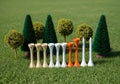 Artificial grass scene featuring various colored golf teesâbeige, white, and orangeâarranged in a Royalty Free Stock Photo