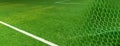 Artificial green grass football or soccer field with white net goal banner background Royalty Free Stock Photo