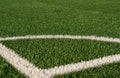 Artificial green grass and white border lines. Artificial turf for soccer field. Football field in an outdoor stadium Royalty Free Stock Photo