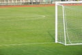 Artificial green grass and white border lines. Artificial turf for soccer field. Football field in an outdoor stadium. Soccer goal Royalty Free Stock Photo