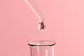 Artificial insemination. Test tube baby, IVF. On the tip of the pipette drop with silhouette of the embryo of the child, dripping