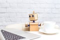 Artificial Intelligence. Cardboard robot work and drink coffee
