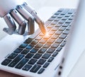 Artificial intelligence concept, robot hand keys computer