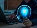 Artificial Intelligence concept with smart brain and AI chip on light bulb in head shape holding by tech developer hand. Machine Royalty Free Stock Photo