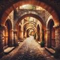a cobblestone pathway winding through a series of medieval stone arches. Royalty Free Stock Photo