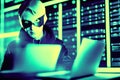 the cyber crime hacker in silhouetted and disguised breaking into the computer server system.
