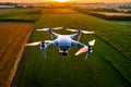 image of flying drone above the farmland field.