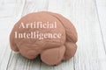 Artificial Intelligence message with model brain on wood Royalty Free Stock Photo